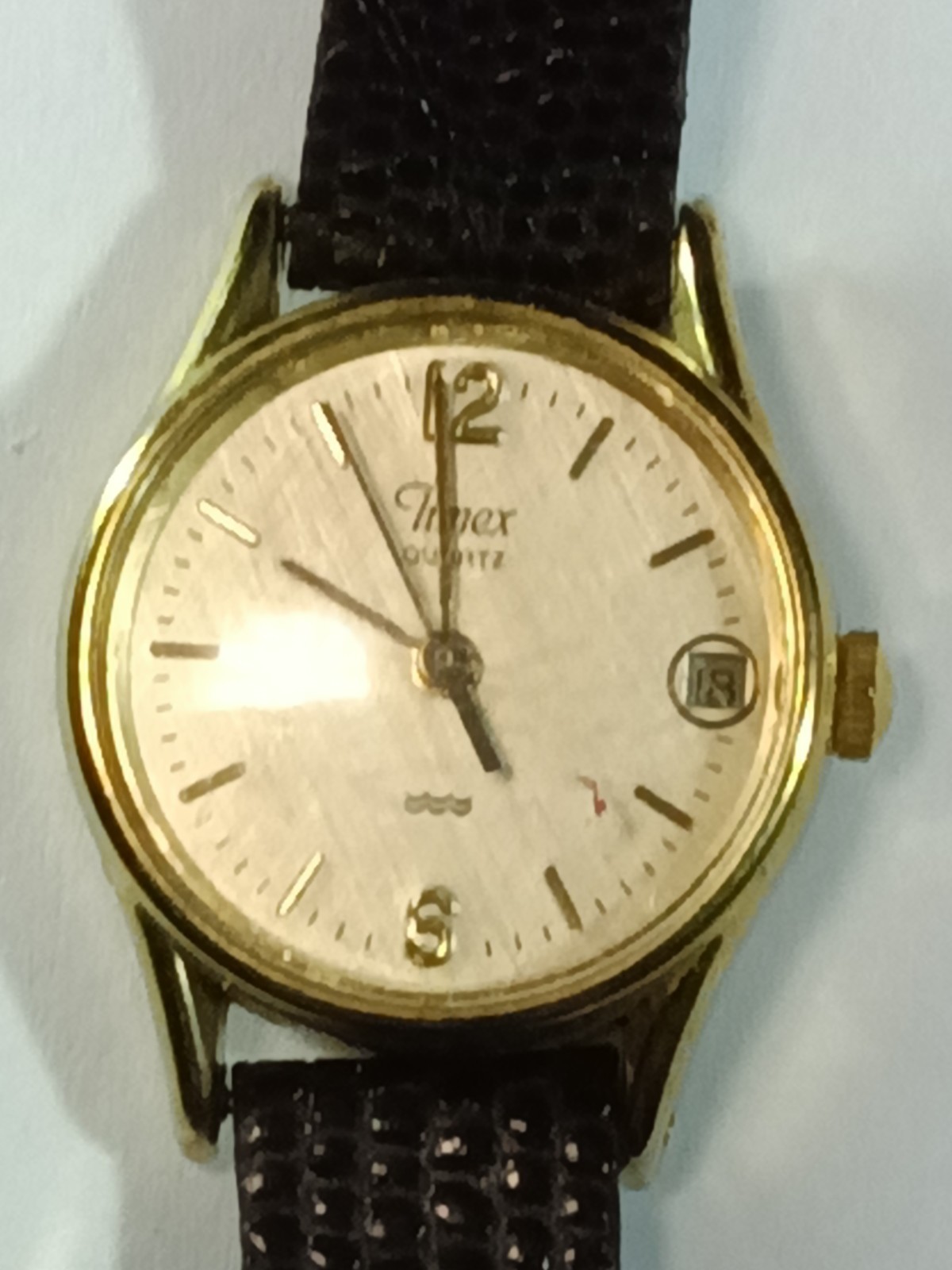 Classic Timex Quartz Analog Watch with a Gold-Tone Round Case