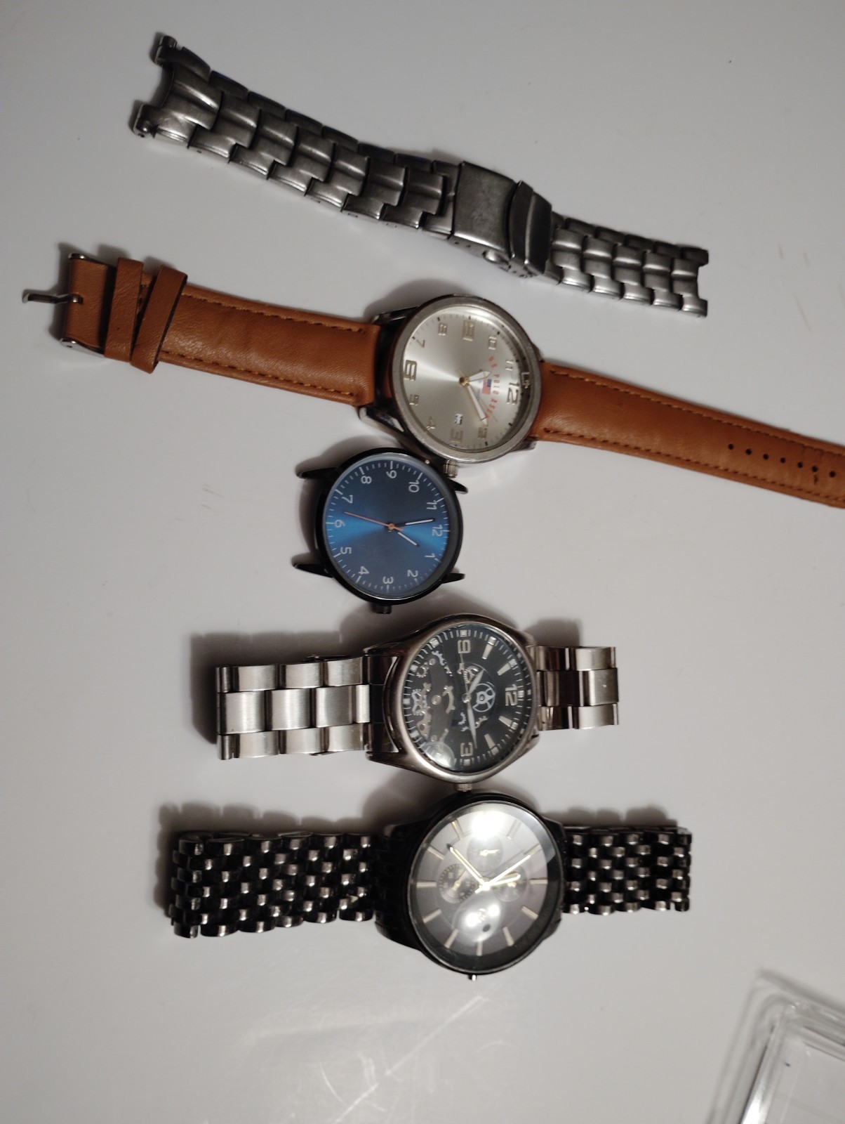 Collection of four fashion watches with various strap styles