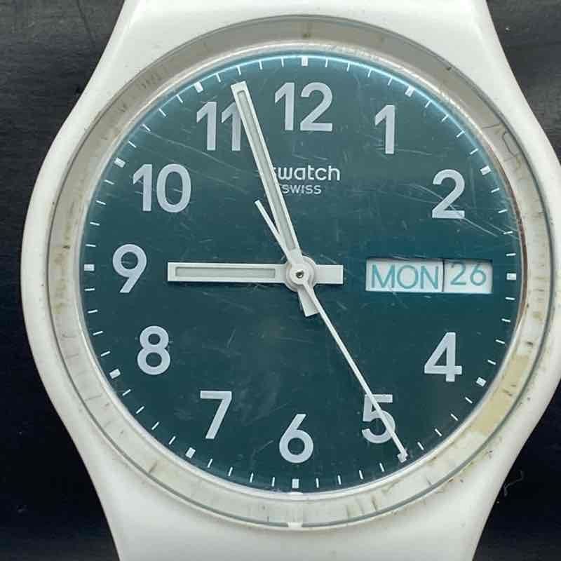 Swatch GW714 Pool Light 34mm Teal Dial Day Date Swiss Quartz Women’s Watch