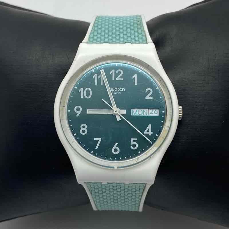 Swatch GW714 Pool Light 34mm Teal Dial Day Date Swiss Quartz Women’s Watch